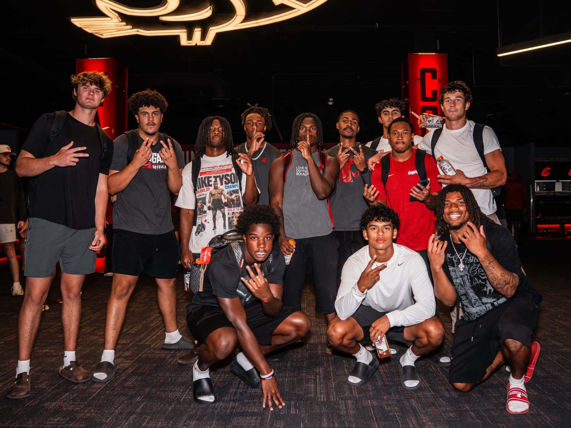 Washington State football players together in the team locker room