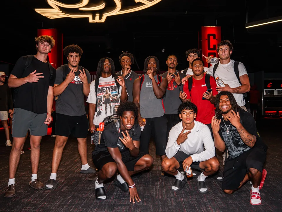 Washington State football players together in the team locker room